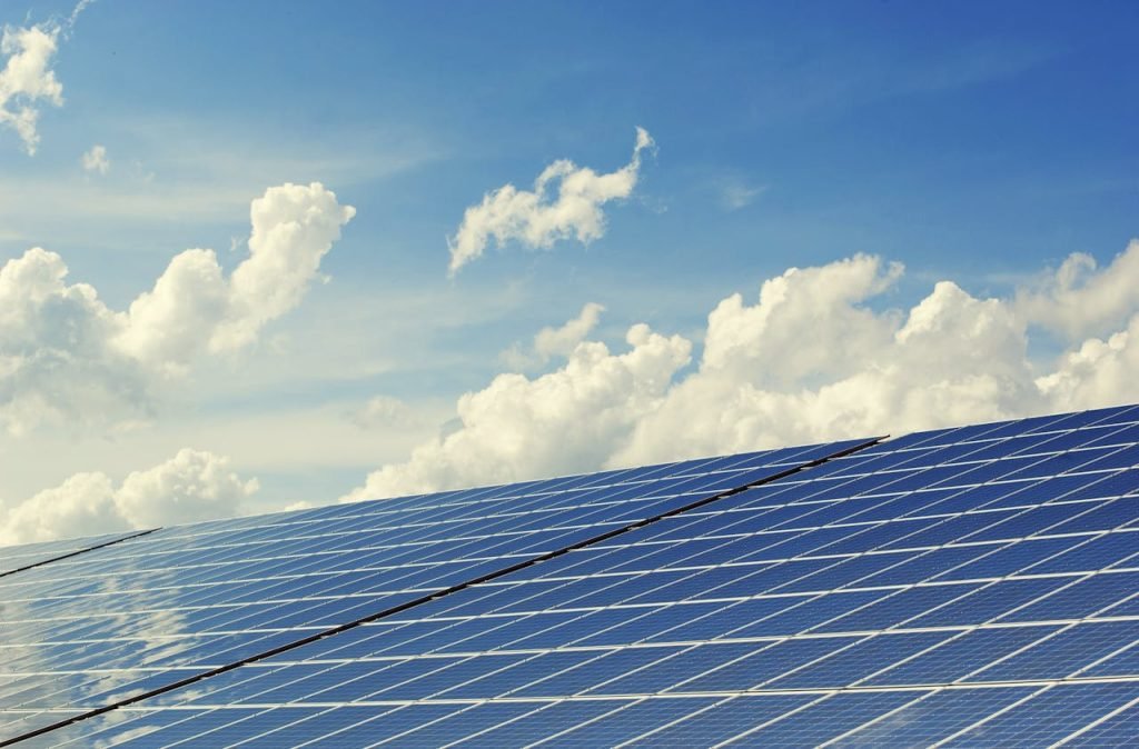 blue-solar-panel-board-356036 Sleek modern solar panels under a vibrant blue sky with clouds, symbolizing clean energy.