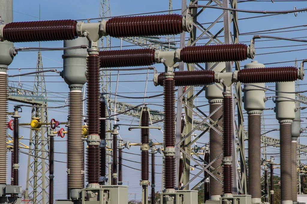 gray-and-black-power-transmission-station-236089 Detailed view of high voltage electrical substation with transformers and power lines.